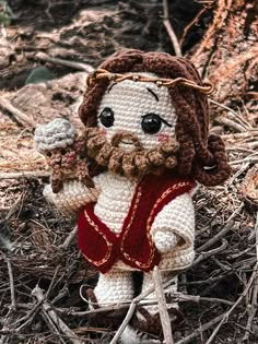 a crocheted jesus figurine holding an ice cream cone in his hand