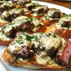 a plate topped with bread covered in cheese and meat