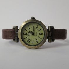 This is a wrist watch, retro minimalist style, exclusive designed by JuSal08. The watch head is made in alloy, free of nickel and lead, aged bronze finish, 1 inch diameter, analog, battery operated (battery included), quartz. The wrist band is made in European vintage leather lends it the perfect patina of age, 10 mm wide. The clasp is magnetic type. The band will be custom size, please select the measure of your wrist from the list. If the measure of your wrist is not in the list, please, send Wrist Watch For Women, Simple Watches, Retro Minimalist, Minimalist Watch, Retro Watches, Aged Bronze, Watch For Women, Simple Leather, Wrist Band