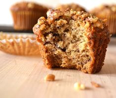 a muffin cut in half sitting on top of a wooden table