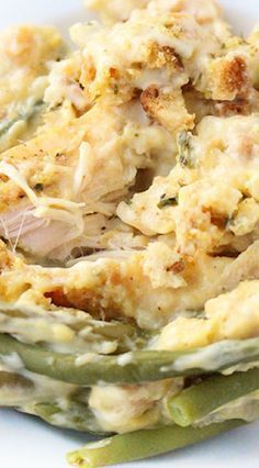 a white plate topped with green beans and chicken casserole covered in gravy