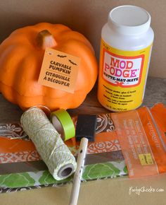 pumpkins and other crafting supplies are on the table next to each other, including glue