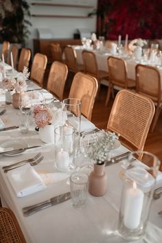 the table is set with white linens and silverware