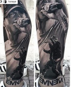 a man's leg with tattoos on it and his arm holding a microphone in front of him