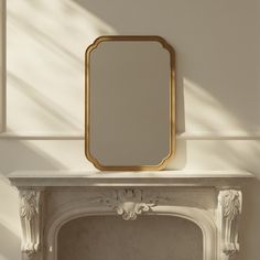 a white fireplace with a mirror on top of it