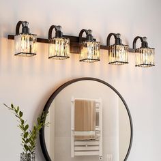 a bathroom with a mirror and lights on the wall