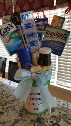 a bottle filled with lots of different items on top of a table