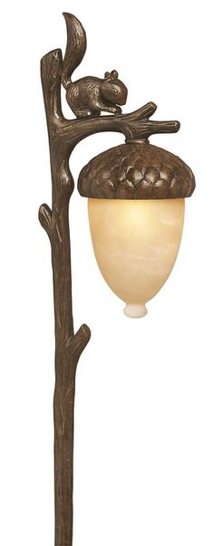 a lamp that is sitting on top of a tree branch with a bird perched on it