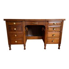 an antique wooden desk with drawers and brass pulls on the bottom drawer, against a white background