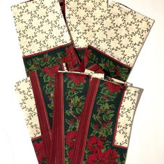 four christmas napkins with poinsettias on them