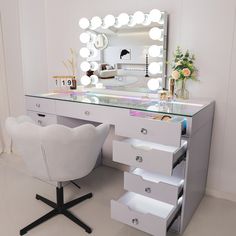 a white chair sitting in front of a vanity with a mirror and lights on it