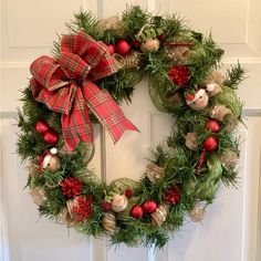 a christmas wreath hanging on the front door