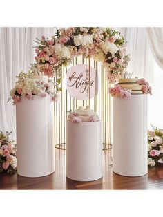 three white vases with flowers on them and a sign that says love is in the middle