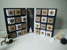 an open card with numbers and decorations on it, sitting next to a small christmas tree