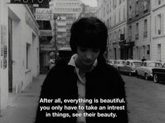 a woman walking down the street with a quote on her face that says, after all, everything is beautiful you only have to take an interest in things see their beauty