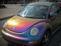 a rainbow colored car is parked on the street