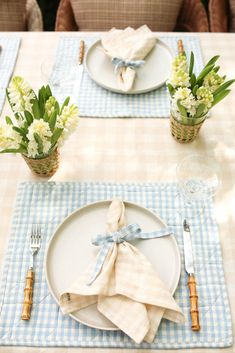 a table set with place settings and napkins