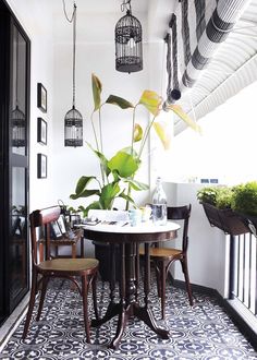 a balcony with plants and chairs on it