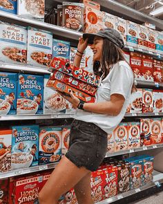 a woman is standing in front of some cereal boxes