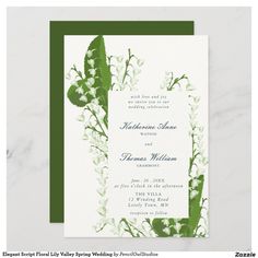 a wedding card with green and white flowers