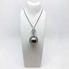 Exquisite 18ct White Gold Tahitian Pearl and Diamond Pendant With Fine Angle Curb Chain This stunning tahitian pearl and diamond white gold pendant has been lovingly handcrafted by Doug in his Cornish workshop. With over 40 years experience in jewellery making, all of our pieces come with an absolute assurance of quality.  Specifications:  Metal: 18ct White Gold Tahitian Pearl: 12mm, fine quality  Diamonds: 12x1mm Round Brilliant White Diamonds  Chain: 18ct White Gold Fine Angle Curb Chain If you have any queries please don't hesitate to contact us directly! Douglas Hughes Fine Jewellery White Gold Tahitian Pearl Jewelry With Diamond Accents, Tahitian Pearl White Gold Jewelry With Diamond Accents, Silver Tahitian Pearl Round Pendant Jewelry, Luxury Tahitian Pearl Jewelry With Diamond Accents, Silver Tahitian Pearl Pendant, Tahitian Pearl Round Pendant Necklace For Formal Occasions, Tahitian Pearl Necklace For Wedding, Classic Tahitian Pearl Pendant Jewelry, Tahitian Pearl Jewelry With Diamond Accents For Wedding