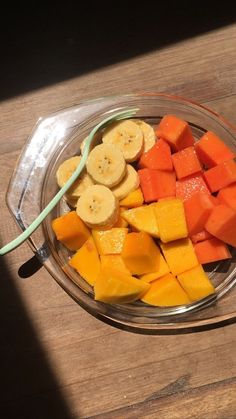 a glass bowl filled with cut up fruit