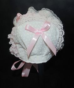 Printed white cotton with pink double sided satin ribbon bows and ties. Bonnet has white lining.. White and pink lace Size / Measurement from under ear lobe around top of head to under other ear lobe preemie/ newborn 10 inches 0-3 months/ 11 inches 3-6 months / 12 inches 6-9 months / 13 inches 9-12 months / 14 inches 12-18 months/ 15 inches 18-24 months / 16 inches Cute Pink Cotton Bonnet, Cute White Fitted Bonnet, Cute Fitted White Bonnet, White Cotton Bonnet As A Gift, White Cotton Bonnet As Gift, Heirloom Bonnet, Lace Baby Bonnet, Newborn Bonnet, Satin Ribbon Bow