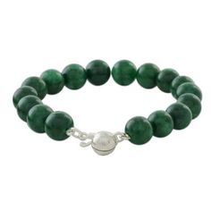 Circling the wrist with a strand of green quartz this beaded bracelet from Thailand brings the voice of the jungle to your wardrobe. Matta designs the bracelet closing it with a clasp crafted of Karen hill tribe silver. A silver bell charm dangles from the clasp.