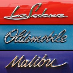 the emblems on three different cars that are red, blue, and yellow in color