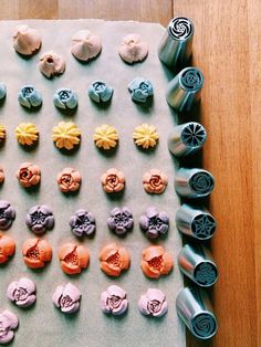 there are many different types of buttons on the table next to each other, including one that has been made with fondant