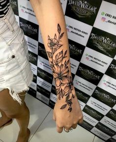 a woman with a flower tattoo on her arm