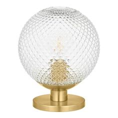 an image of a glass ball on a metal stand with a gold base and knob