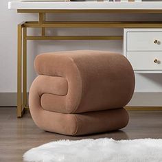 a chair sitting on top of a wooden floor next to a white rug and table