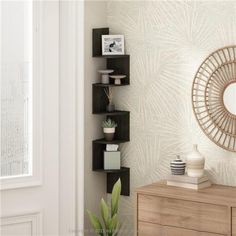 a room with a mirror, plant and other items on the shelf in front of it