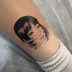 a woman's arm with a black and white portrait tattoo on the left forearm