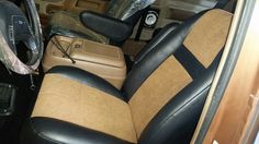 the interior of a vehicle with black and tan leather seats, steering wheel cover and center console