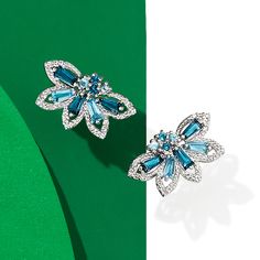 Ross-Simons - .96ct t. w. Tonal Blue Topaz, .10ct t. w. Diamond Earrings in Silver. This wintry pair will add a touch of cool elegance to your ensemble. Round and tapered baguettes of London and Swiss blue topaz totaling .96 carats are sparked by .10 ct. t. w. diamonds in a floral design set in sterling silver. Hanging length is 3/8". Post/clutch, diamond and tonal blue topaz earrings. Blue Topaz birthstones are the perfect gift for December birthdays. Fine Jewelry Blue Cluster Earrings, Blue Cluster Earrings In Fine Jewelry Style, Blue Cluster Earrings Fine Jewelry, Blue Cluster Earrings For Anniversary, Topaz Birthstone, December Birthday, Blue Topaz Earrings, Fine Jewelery, Topaz Earrings