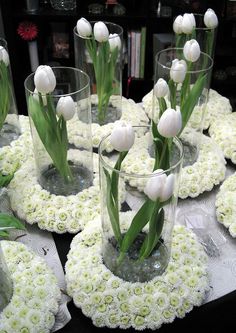 several vases with flowers in them sitting on a table