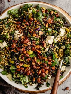 a white bowl filled with salad on top of a wooden board