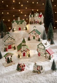 a christmas village with lights and snow on the ground