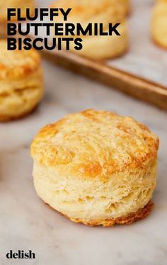 buttermilk biscuits on a baking sheet with text overlay that reads fluffy buttermilk biscuits