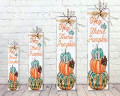 three wooden signs with pumpkins painted on them and the words hey, there are pumpkins