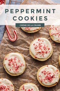 peppermint cookies with white frosting and sprinkles on parchment paper