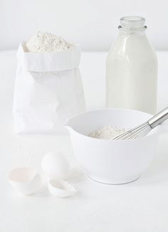 a white table topped with eggs and flour