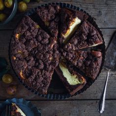 a chocolate cake is cut into slices on a wooden table