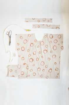 sewing supplies are laid out on a white surface