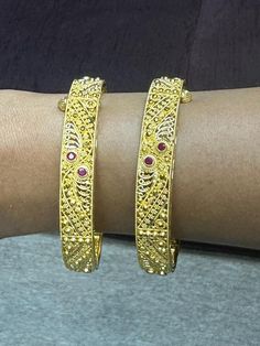 22 karat gold kada  - set of 2 (1 pair) with color stones   
    note: this item comes with a screw and hinge so that you can open it up for easy wearing.    

enhance your style with our 22 karat gold kada set  indulge in the beauty of indian craftsmanship with our 22 karat gold kada set. designed for women, this exquisite piece of jewelry is perfect for adult individuals who appreciate fine accessories that elevate their style.  with a total gross gold weight of 39.950 grams, our kad Gold Kada, Color Stones, 22k Gold, Can Opener, Stone Color, Screw, Stone, Gold, Beauty