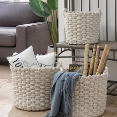 two woven baskets sitting on top of a wooden floor