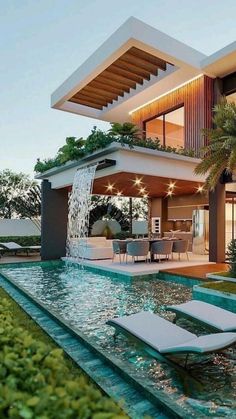 a modern house with a pool and lounge chairs