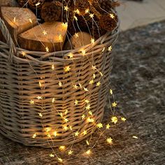 a basket filled with logs and christmas lights